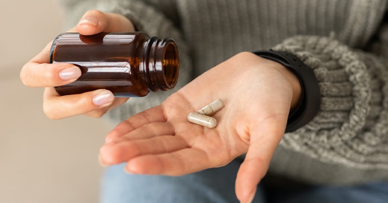 a hand holding a remote control